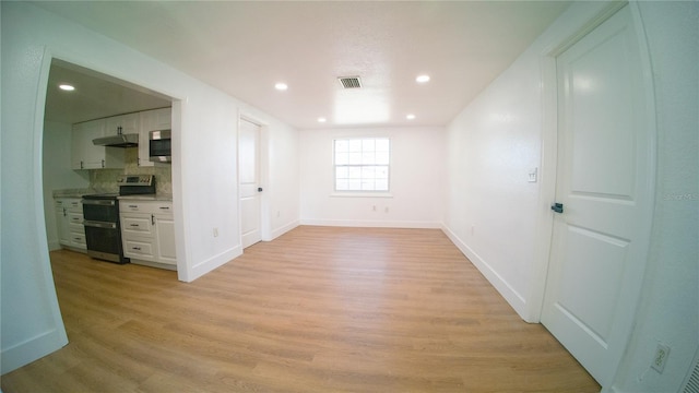 spare room with recessed lighting, baseboards, visible vents, and light wood finished floors