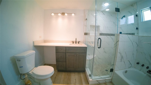 full bathroom with toilet, wood finished floors, a garden tub, vanity, and a shower stall