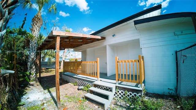 exterior space with concrete block siding and a deck