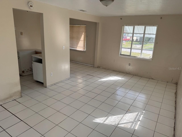 unfurnished room featuring light tile patterned floors and visible vents