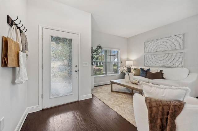 living area featuring baseboards and wood finished floors