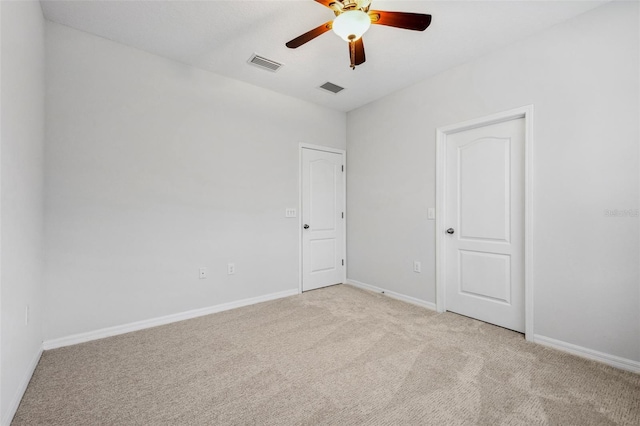 spare room featuring baseboards, visible vents, ceiling fan, and carpet flooring