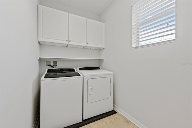 clothes washing area featuring cabinet space, baseboards, and separate washer and dryer