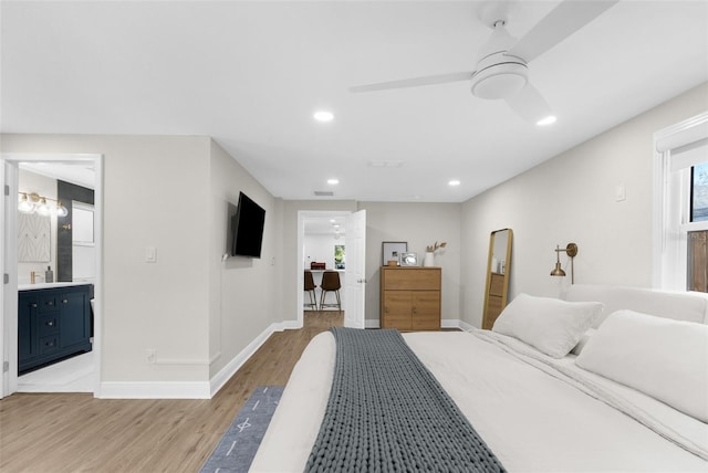 bedroom featuring recessed lighting, a ceiling fan, baseboards, light wood finished floors, and ensuite bath