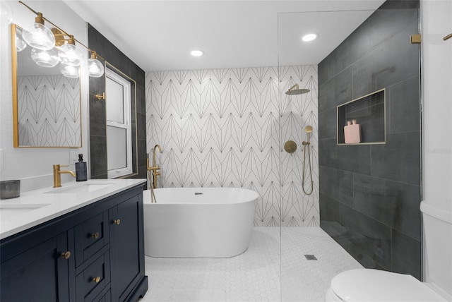 bathroom featuring a sink, tile walls, a freestanding bath, double vanity, and walk in shower