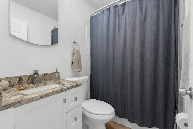 full bathroom with toilet, wood finished floors, and vanity