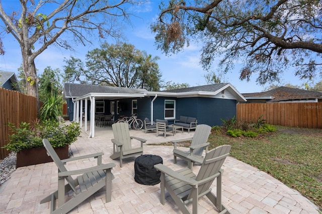 rear view of house featuring fence private yard, a patio area, and an outdoor living space