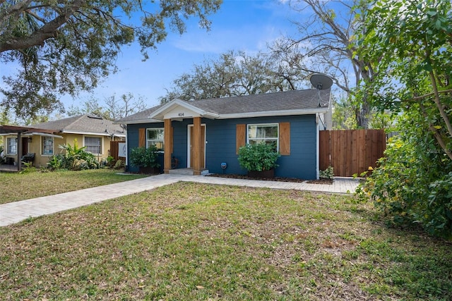 view of front of property with fence and a front lawn