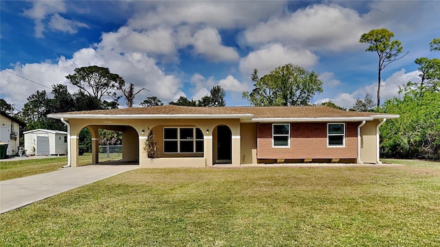 single story home with a shed, a front lawn, and a carport