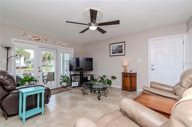 living room with ceiling fan, french doors, and baseboards