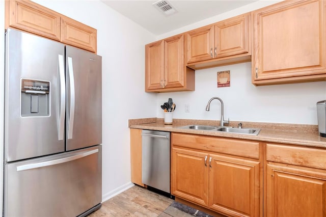 kitchen featuring a sink, visible vents, baseboards, light countertops, and appliances with stainless steel finishes