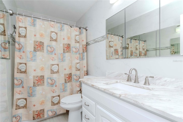 full bathroom with toilet, curtained shower, vanity, and tile walls