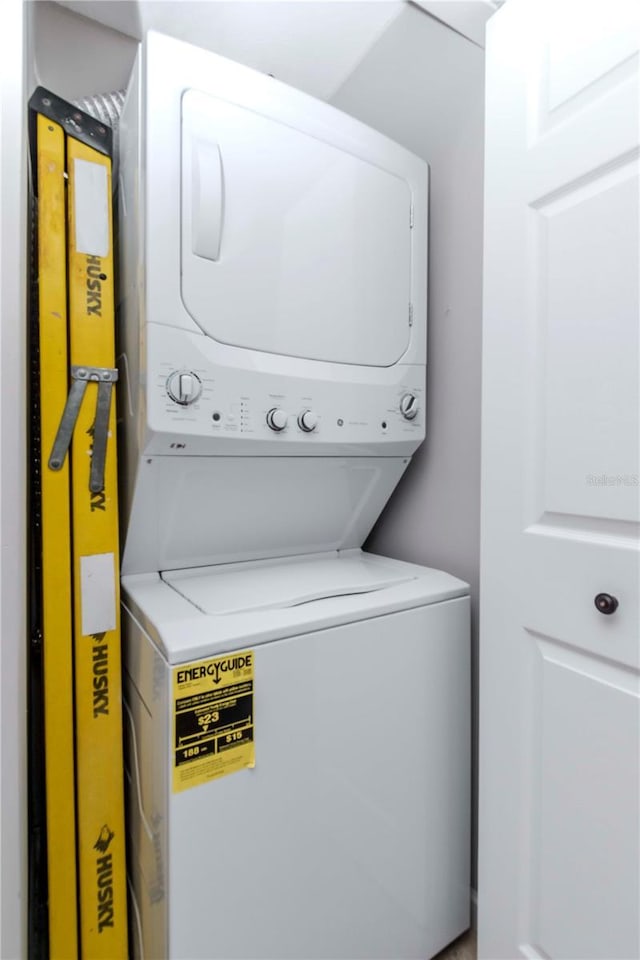 washroom with laundry area and stacked washer / drying machine