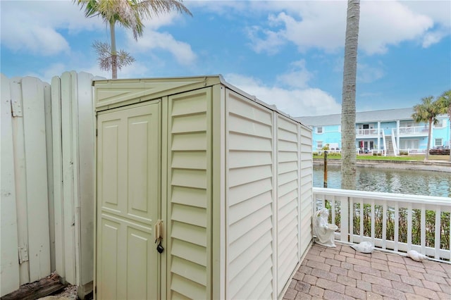 view of shed with a water view