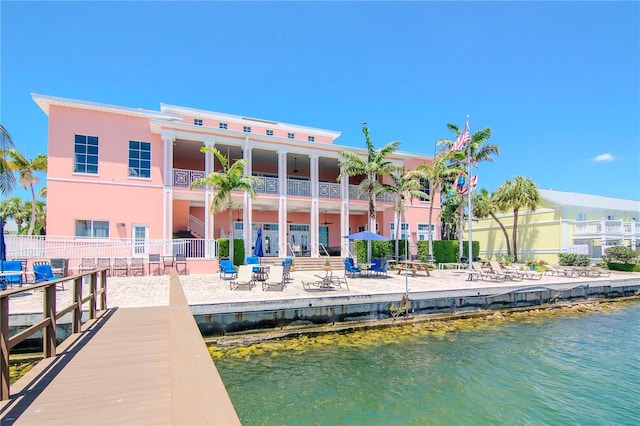 dock area with a water view and fence