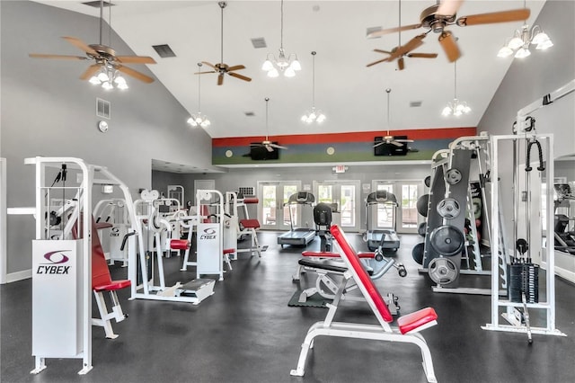 exercise room with visible vents, vaulted ceiling, and baseboards