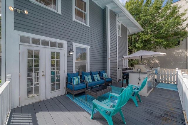 wooden terrace with an outdoor hangout area and french doors