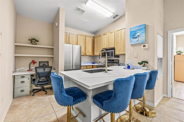 kitchen featuring light tile patterned floors, light brown cabinets, stainless steel appliances, visible vents, and light countertops