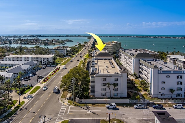 birds eye view of property with a water view and a city view