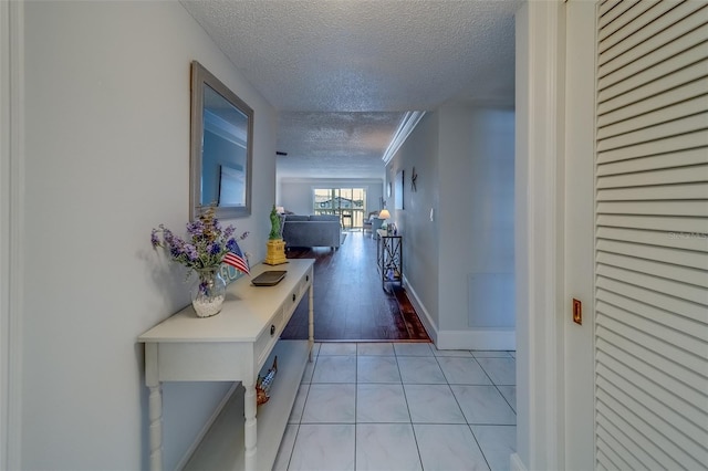 131 Bluff View Dr Unit 208, Belleair Bluffs, FL 33770 - hallway featuring a textured ceiling and light tile patterned floors