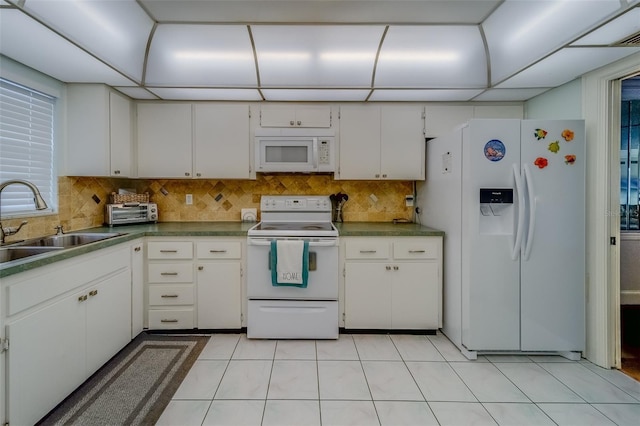 131 Bluff View Dr Unit 208, Belleair Bluffs, FL 33770 - kitchen featuring white appliances, white cabinetry, backsplash, and light tile patterned floors