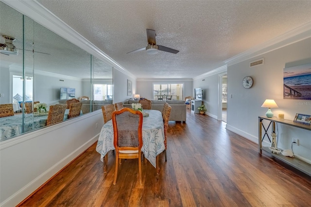 131 Bluff View Dr Unit 208, Belleair Bluffs, FL 33770 - dining room featuring ornamental molding, dark wood-style flooring, a ceiling fan, and a textured ceiling