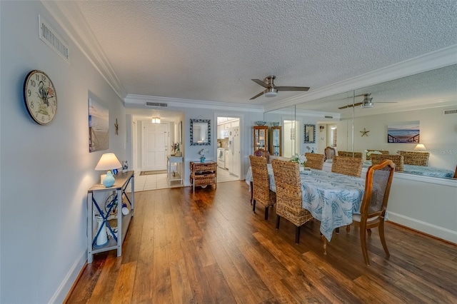 131 Bluff View Dr Unit 208, Belleair Bluffs, FL 33770 - dining space with a textured ceiling, ornamental molding, wood finished floors, and a ceiling fan