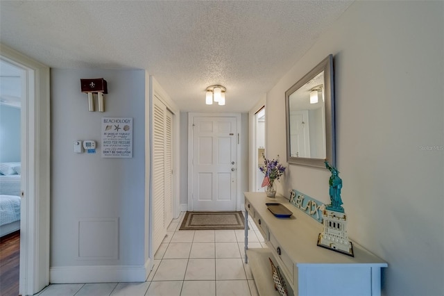 131 Bluff View Dr Unit 208, Belleair Bluffs, FL 33770 - entrance foyer featuring a textured ceiling and light tile patterned floors