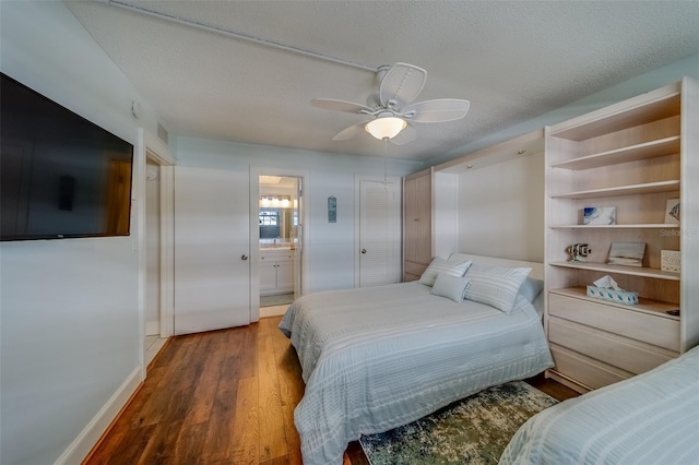 131 Bluff View Dr Unit 208, Belleair Bluffs, FL 33770 - bedroom with wood finished floors, a textured ceiling, a ceiling fan, and ensuite bathroom