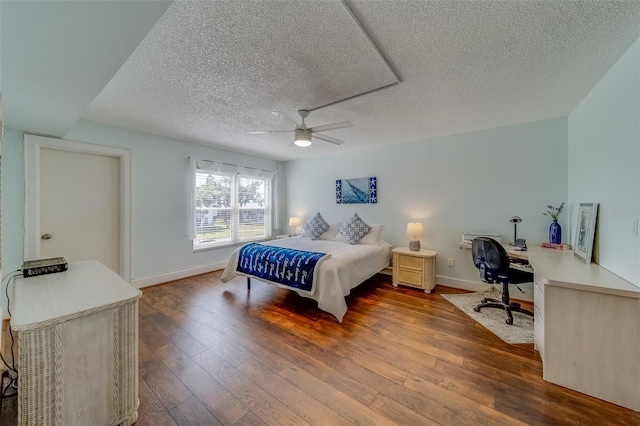 131 Bluff View Dr Unit 208, Belleair Bluffs, FL 33770 - bedroom with wood-type flooring, a textured ceiling, a desk, and a ceiling fan