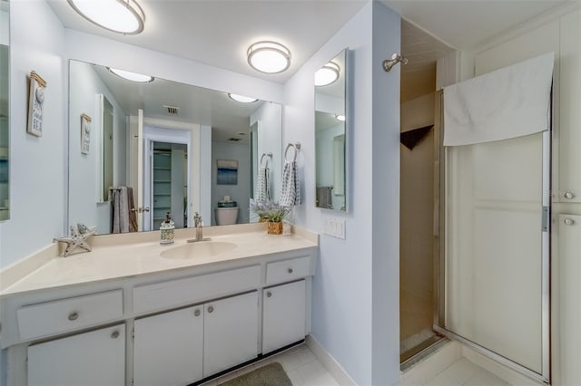 131 Bluff View Dr Unit 208, Belleair Bluffs, FL 33770 - bathroom featuring vanity, a shower stall, and tile patterned flooring
