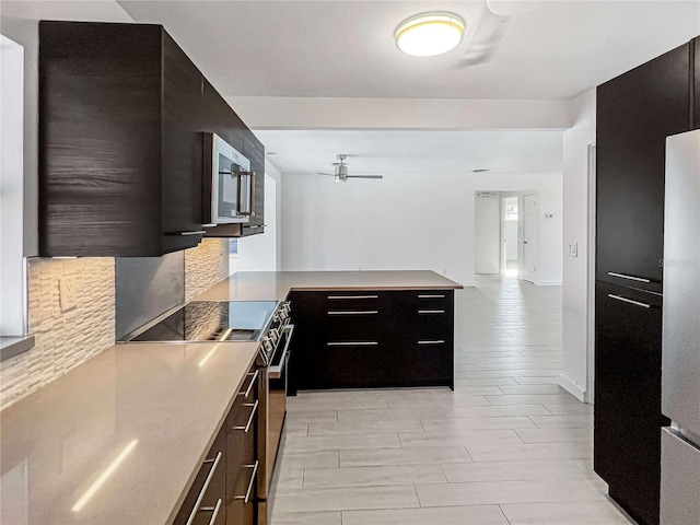 kitchen featuring stainless steel appliances, light wood finished floors, modern cabinets, and light countertops