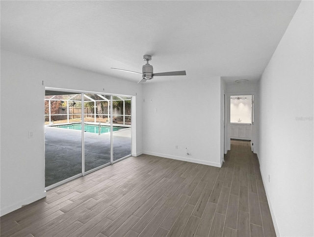 interior space with ceiling fan, baseboards, and wood finished floors