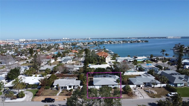 drone / aerial view featuring a residential view and a water view