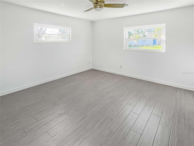 empty room with light wood-style flooring and baseboards