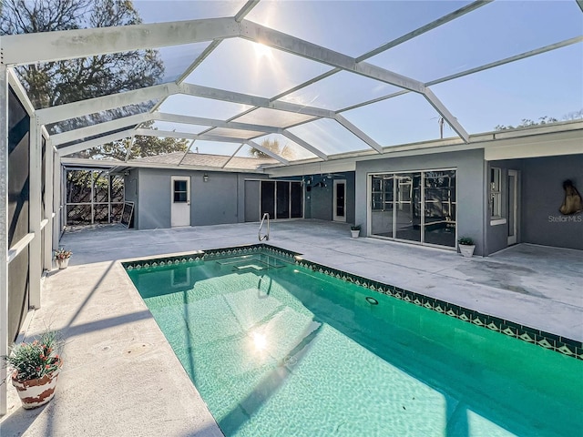 pool featuring a lanai and a patio area