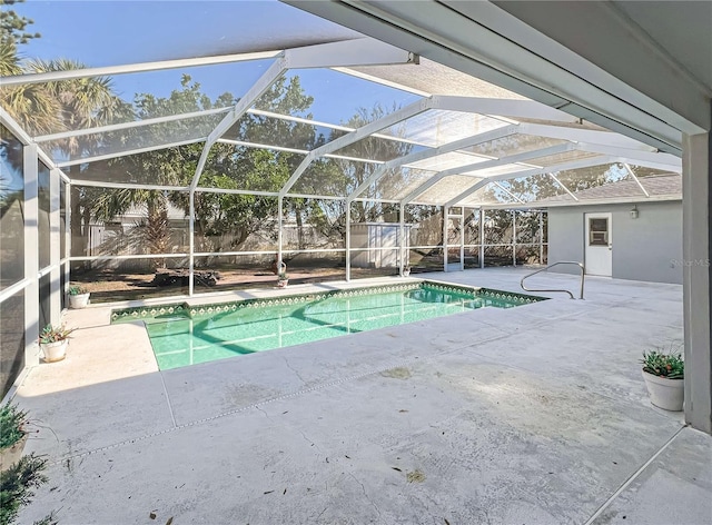 view of swimming pool featuring a fenced in pool, a lanai, a patio area, and a shed