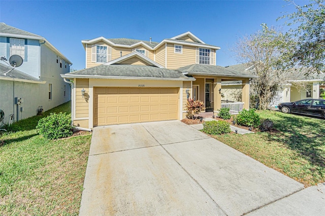 view of property with a front lawn, a garage, and a porch