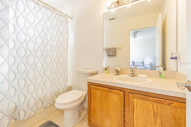 full bathroom featuring tile patterned flooring, shower / tub combo, vanity, and toilet