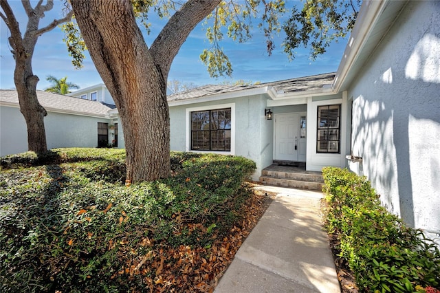 property entrance with stucco siding