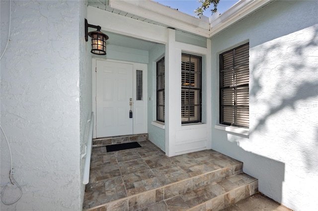 property entrance with stucco siding