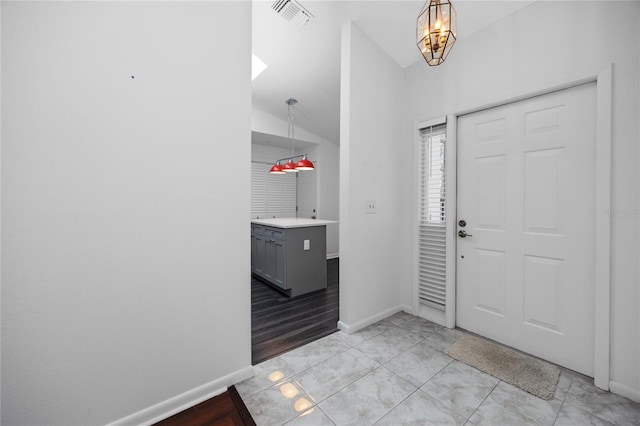 entrance foyer with light tile patterned floors, visible vents, and baseboards