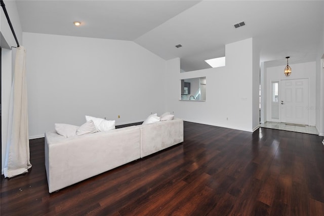 living room with lofted ceiling, dark wood-style floors, visible vents, and baseboards