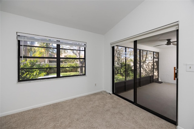 unfurnished room featuring light carpet, ceiling fan, baseboards, and lofted ceiling