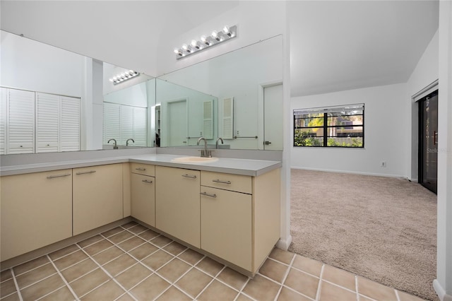 full bathroom featuring double vanity, a closet, a towering ceiling, a sink, and tile patterned floors