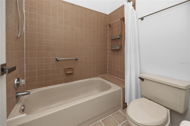 bathroom featuring toilet, shower / tub combo, and tile patterned flooring