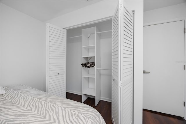 bedroom featuring dark wood-style floors and baseboards