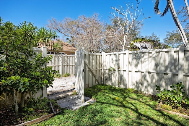 view of yard with fence and a gate