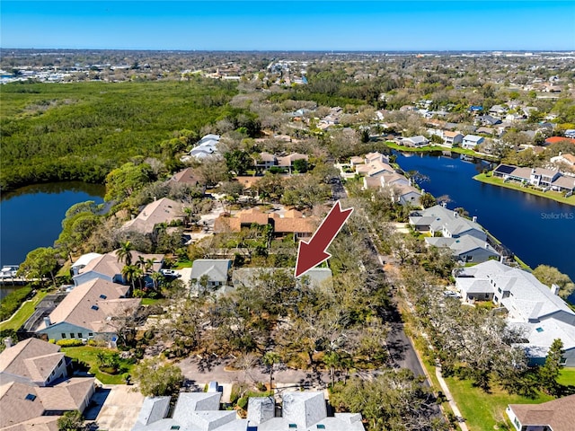 birds eye view of property with a water view and a residential view