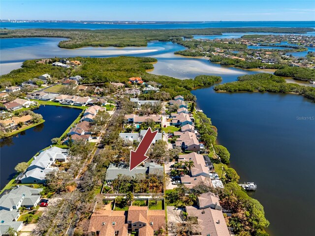 birds eye view of property featuring a water view and a residential view